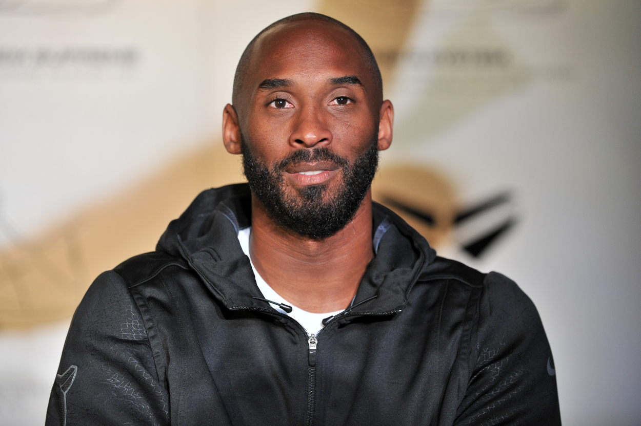 Lakers star Kobe Bryant speaks to the media in 2016 while wearing a black zip-up. | Allen Berezovsky/Getty Images