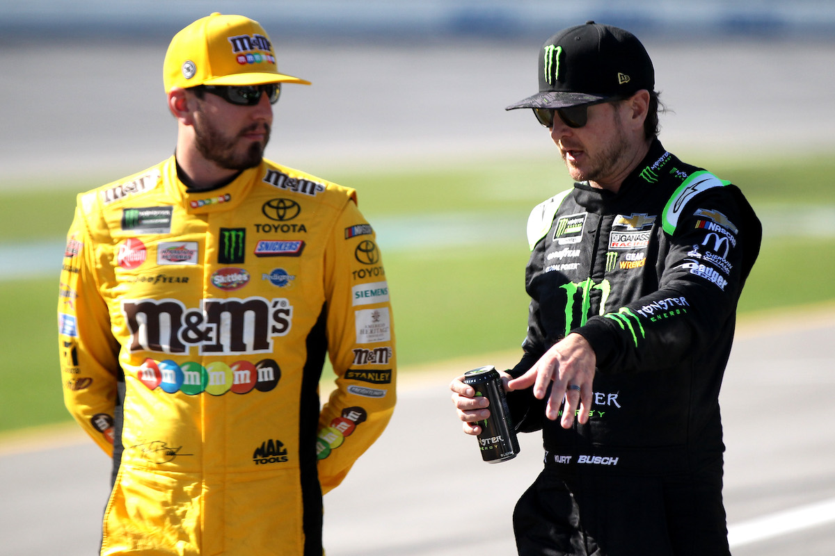 Kyle Busch and Kurt Busch stand on the grid during qualifying for the Monster Energy NASCAR Cup Series GEICO 500 at Talladega Superspeedway on April 27, 2019, in Talladega, Alabama