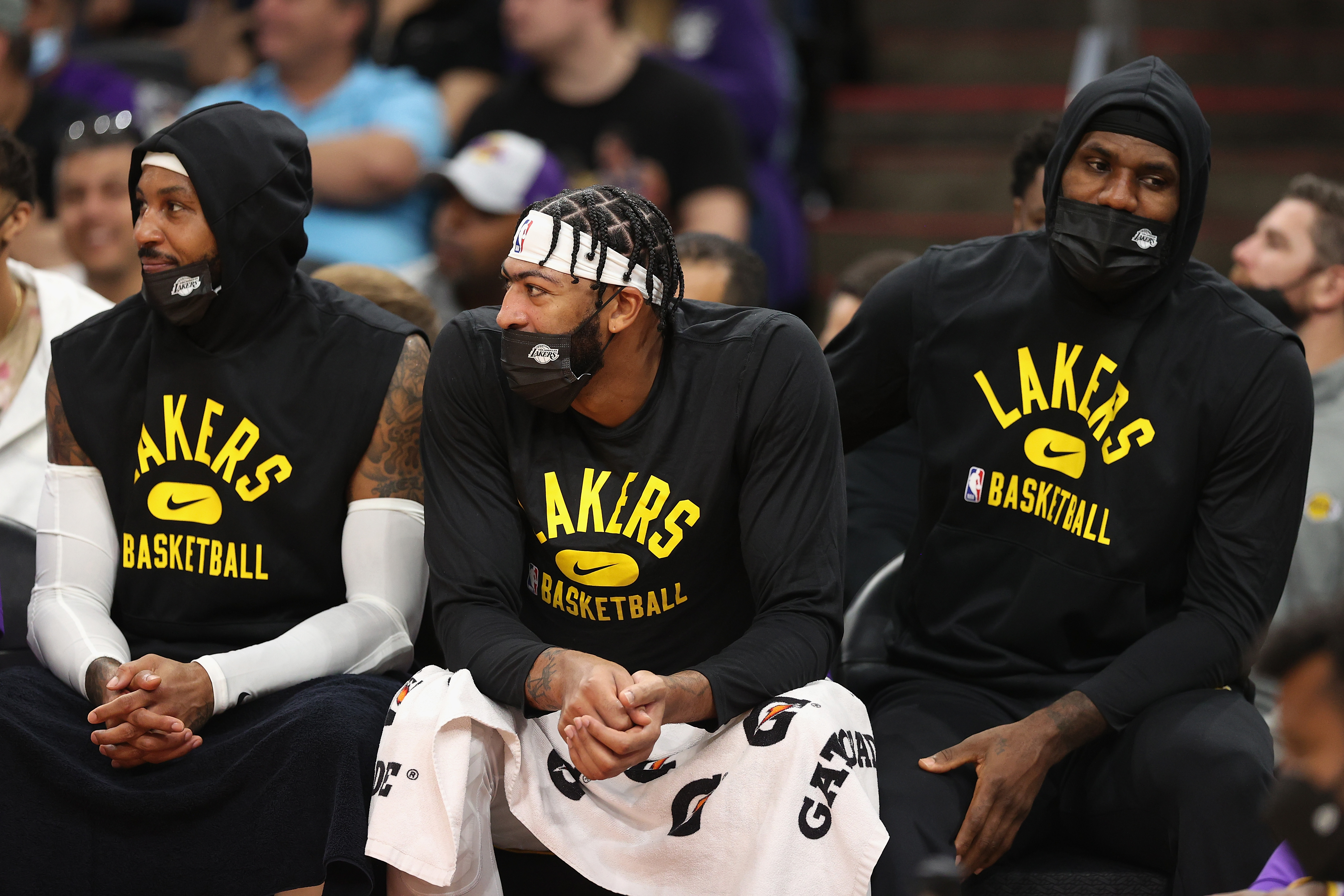 From Left: Carmelo Anthony, Anthony Davis, and LeBron James on the bench during a Lakers preseason game against the Phoenix Suns,