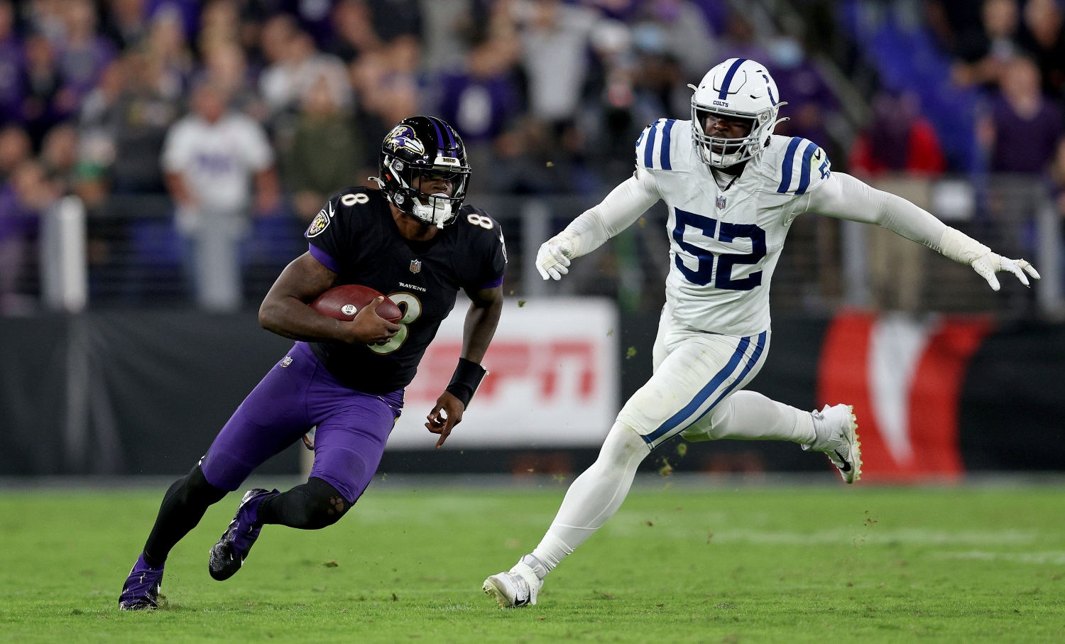 Baltimore Ravens quarterback Lamar Jackson tries to outrun an Indianapolis Colts defender.