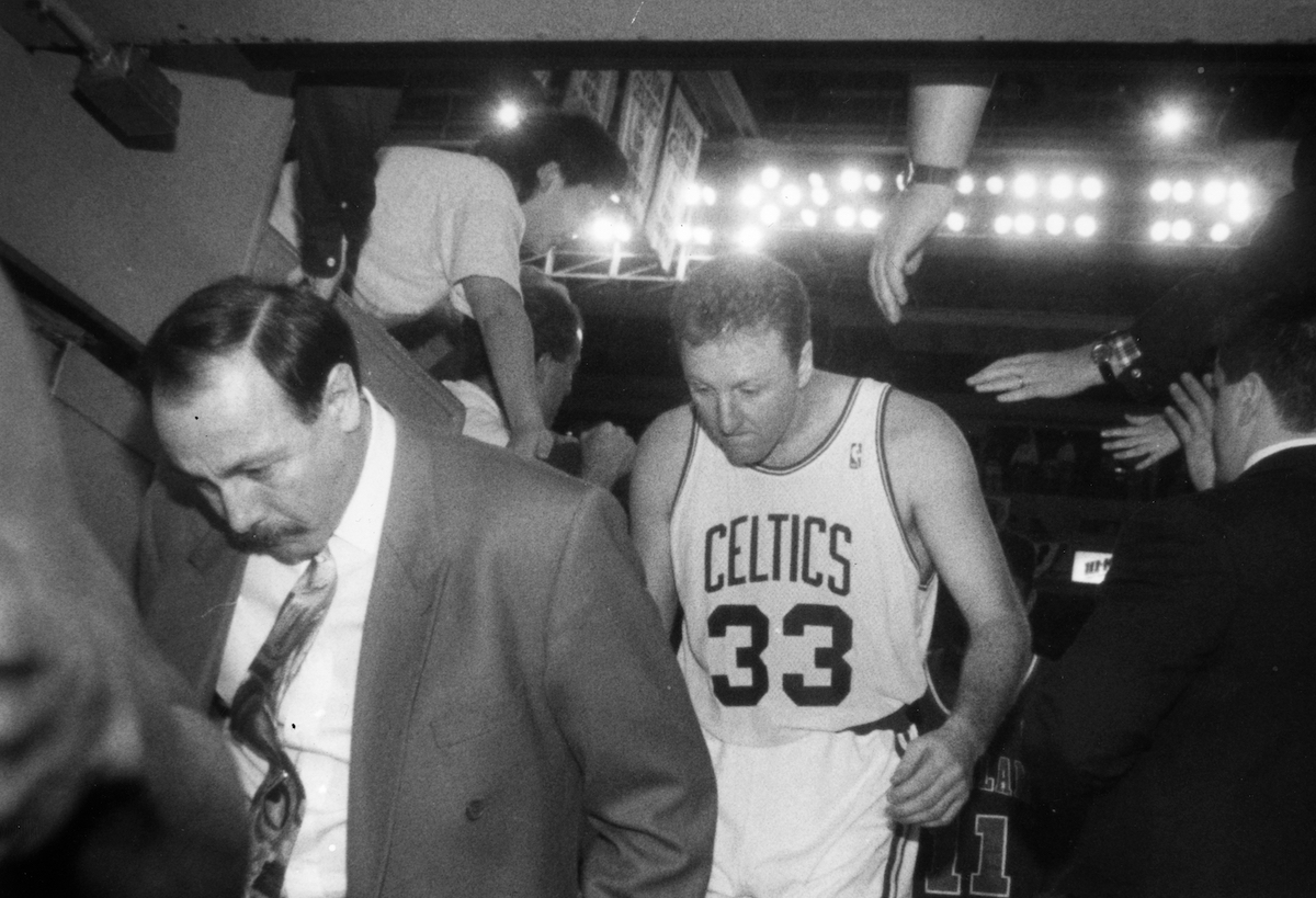Boston Celtics head coach Chris Ford and player Larry Bird exit a game through the tunnel in 1992