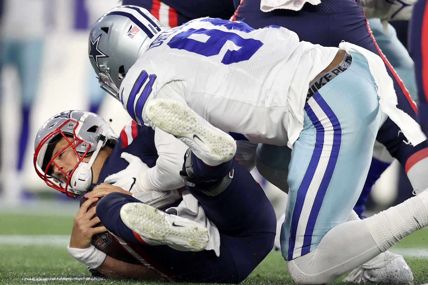 Dallas Cowboys defensive end Randy Gregory sacks New England Patriots quarterback Mac Jones.