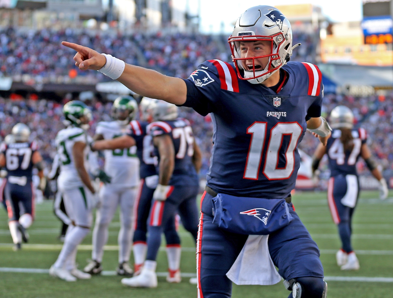 New England Patriots QB Mac Jones celebrates after scoring a touchdown.