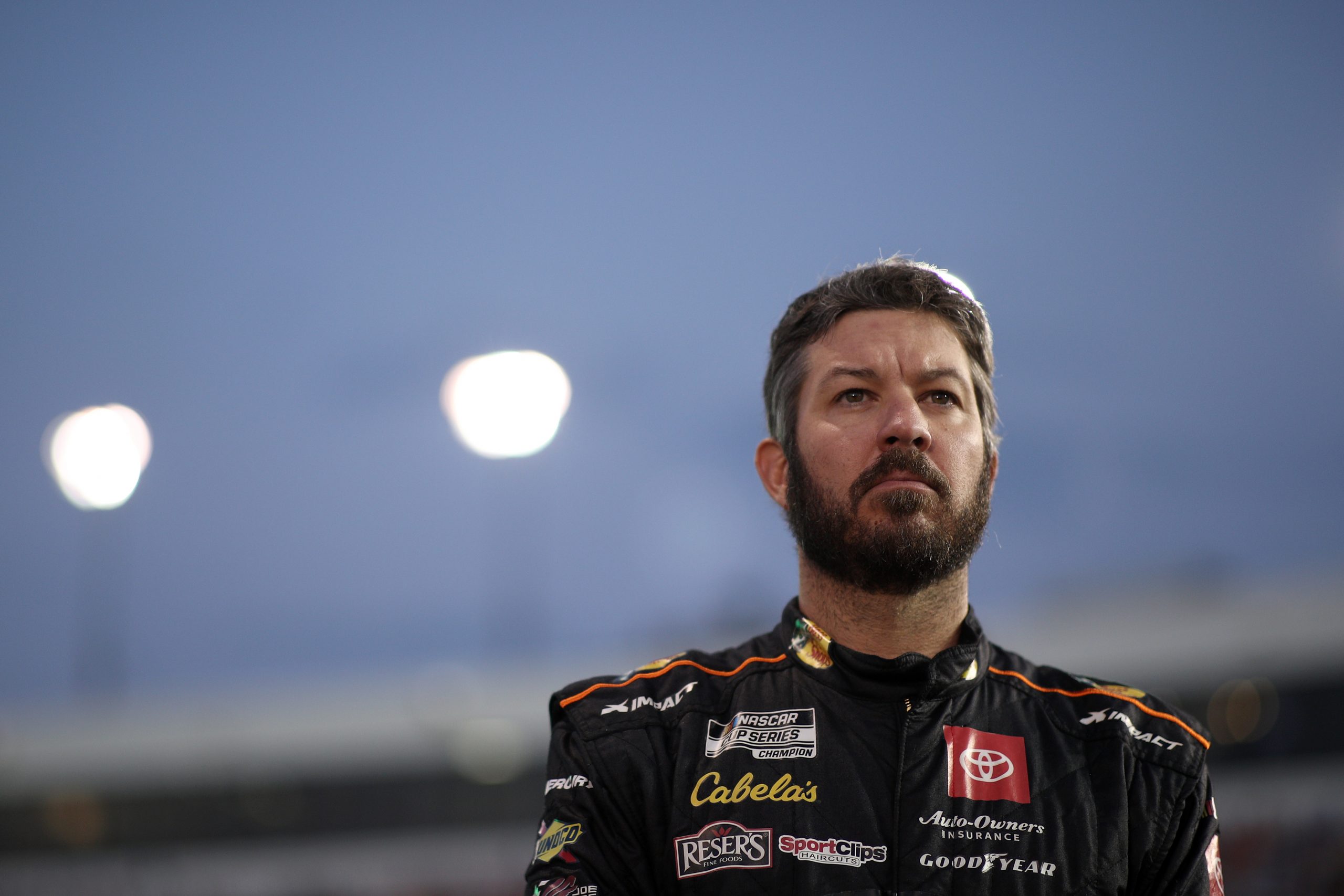 Martin Truex Jr., driver of the No. 19 Toyota, stands on the grid during the national anthem prior to the NASCAR Cup Series Federated Auto Parts 400 Salute to First Responders at Richmond Raceway on Sept. 11, 2021.