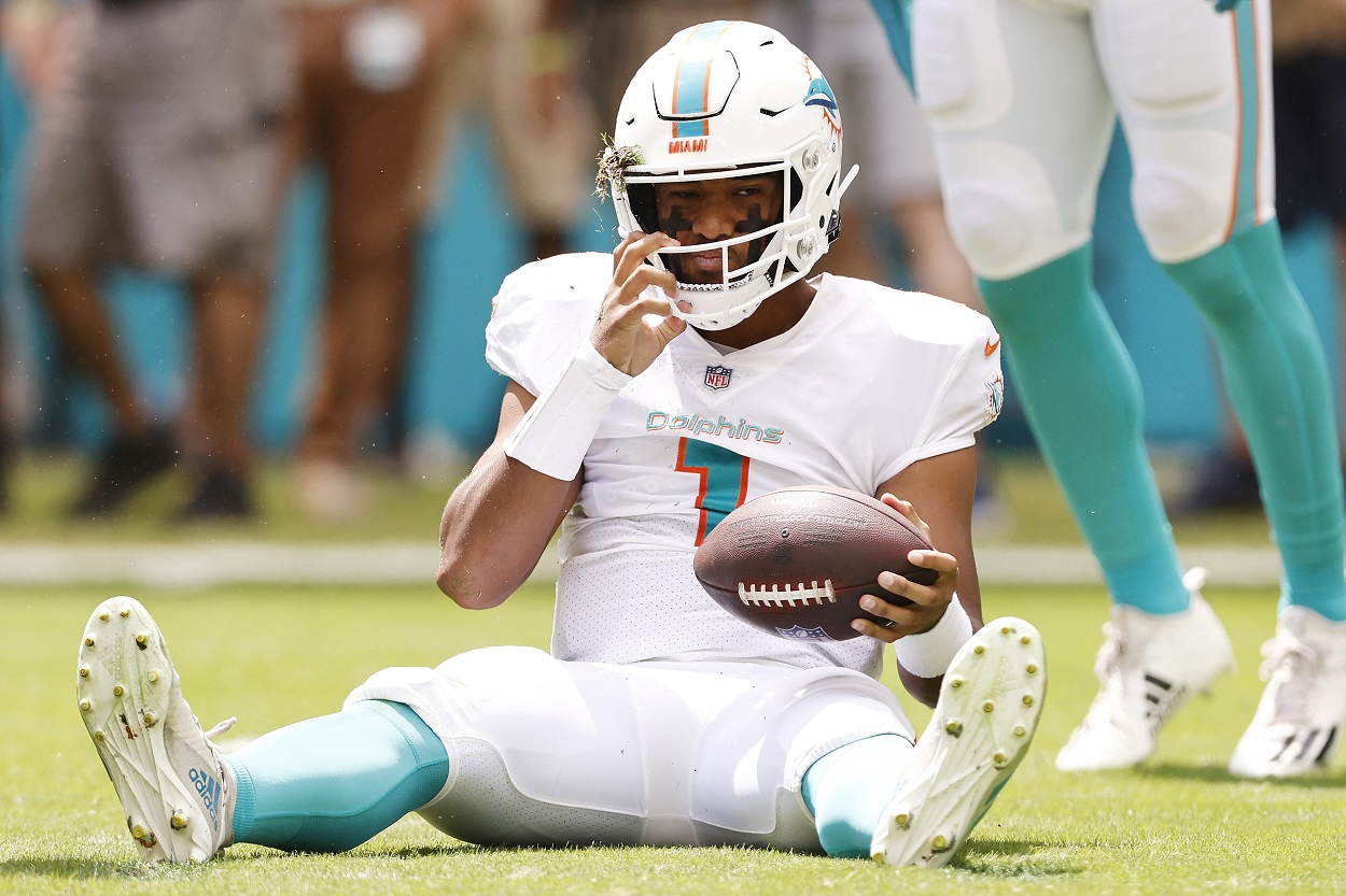 Tua Tagovailoa of the Miami Dolphins reacts to a play while on the ground.