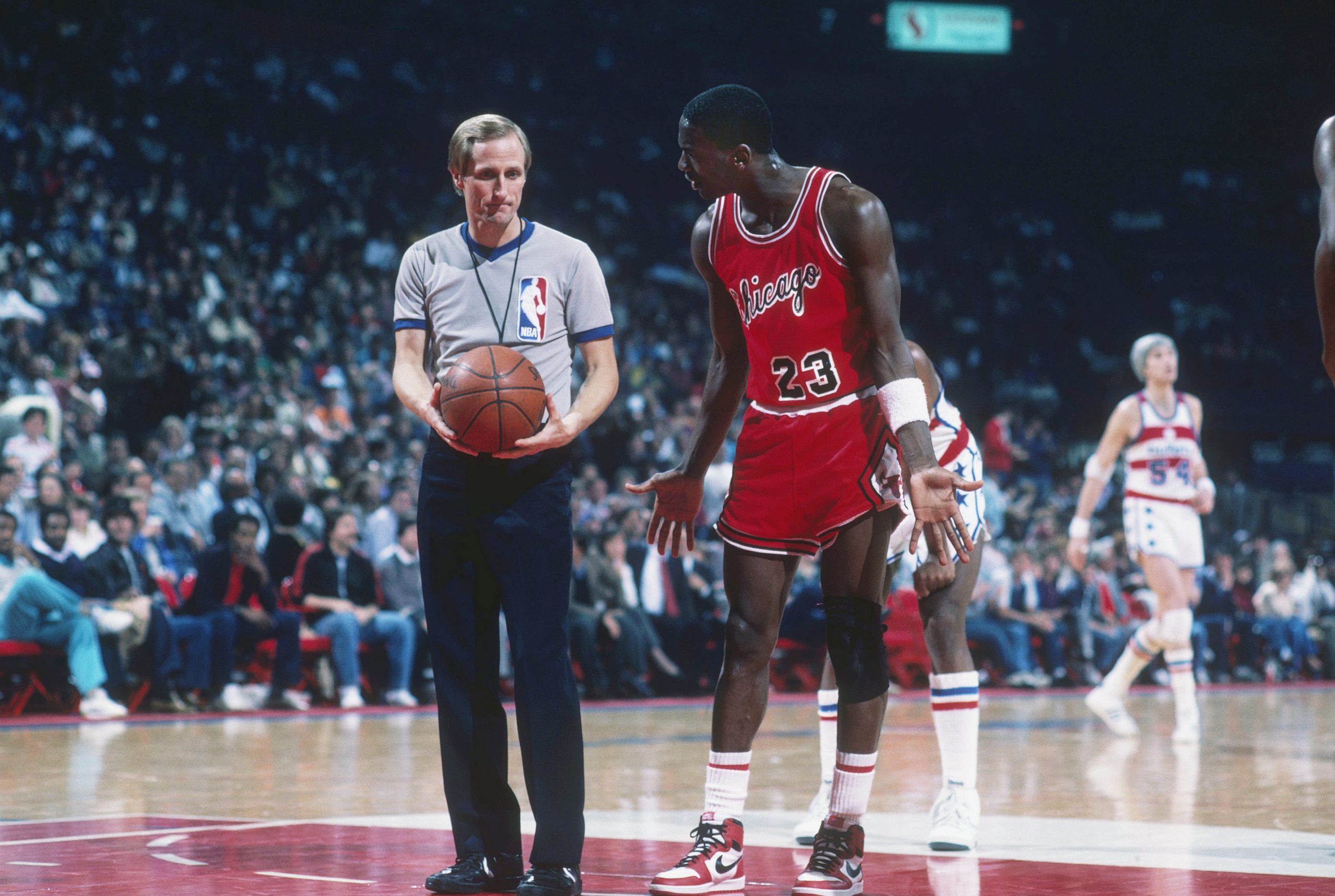Chicago Bulls forward Michael Jordan shrugs his shoulders as he talks to a referee.
