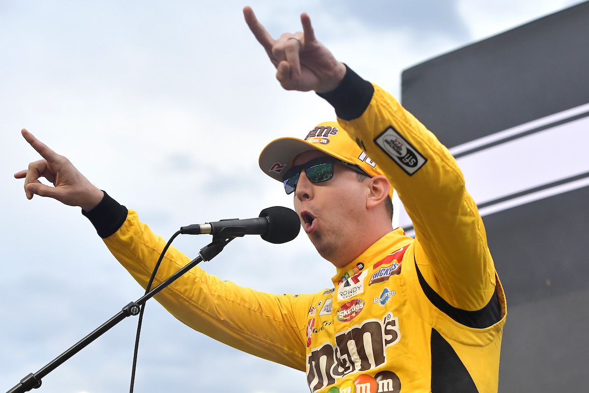 Kyle Busch, driver of the #18 M&M's Toyota, speaks to fans on stage