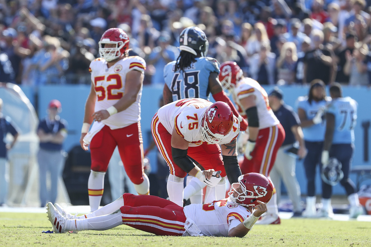 Patrick Mahomes of the Kansas City Chiefs is helped off the field by Mike Remmers in the fourth quarter against the Tennessee Titans in the game at Nissan Stadium on October 24, 2021 in Nashville, Tennessee.