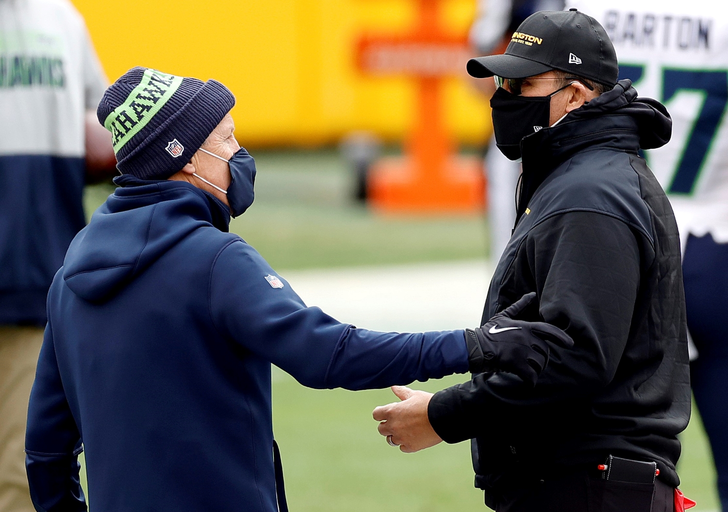 Seattle Seahawks head coach Pete Carroll speaks to Ron Rivera of the Washington Football Team before their teams play.