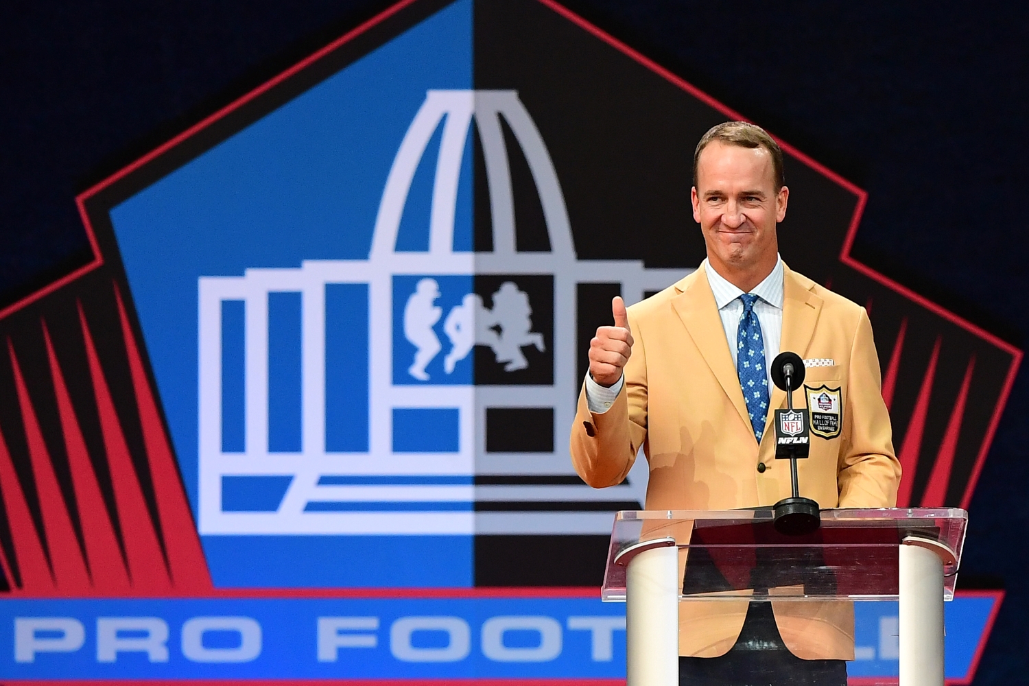 Peyton Manning reacts to the crowd during his Pro Football Hall of Fame induction ceremony speech.