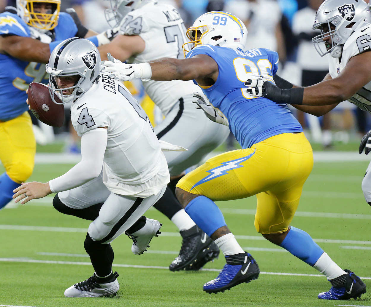 Raiders QB Derek Carr getting sacked.