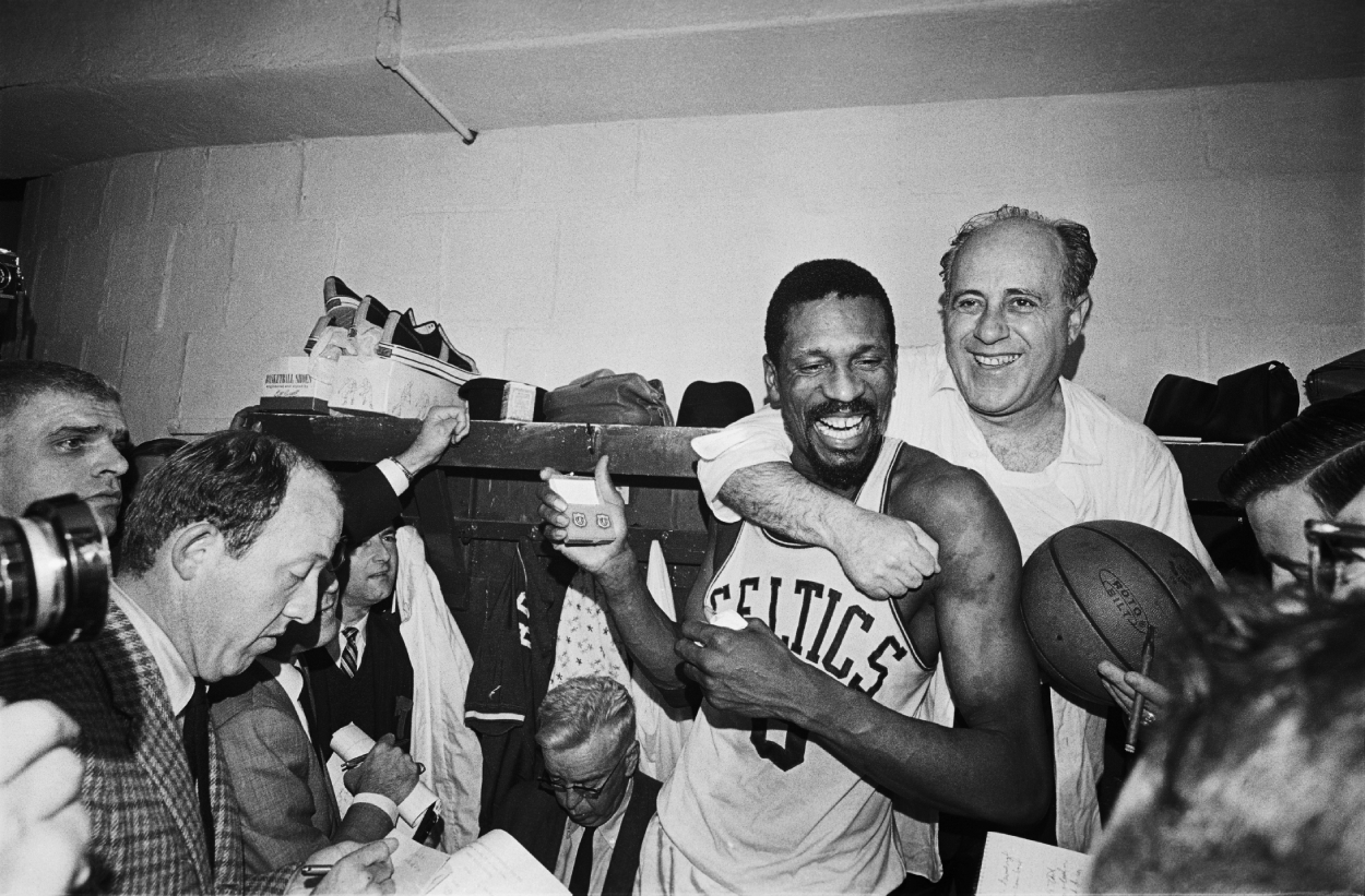 Red Auerbach hugs Bill Russell after winning his eighth straight NBA championship.