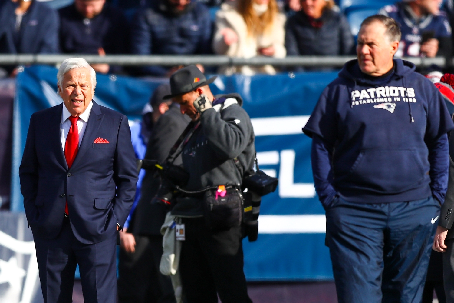 New England Patriots owner Robert Kraft stands on the sidelines near Bill Belichick.