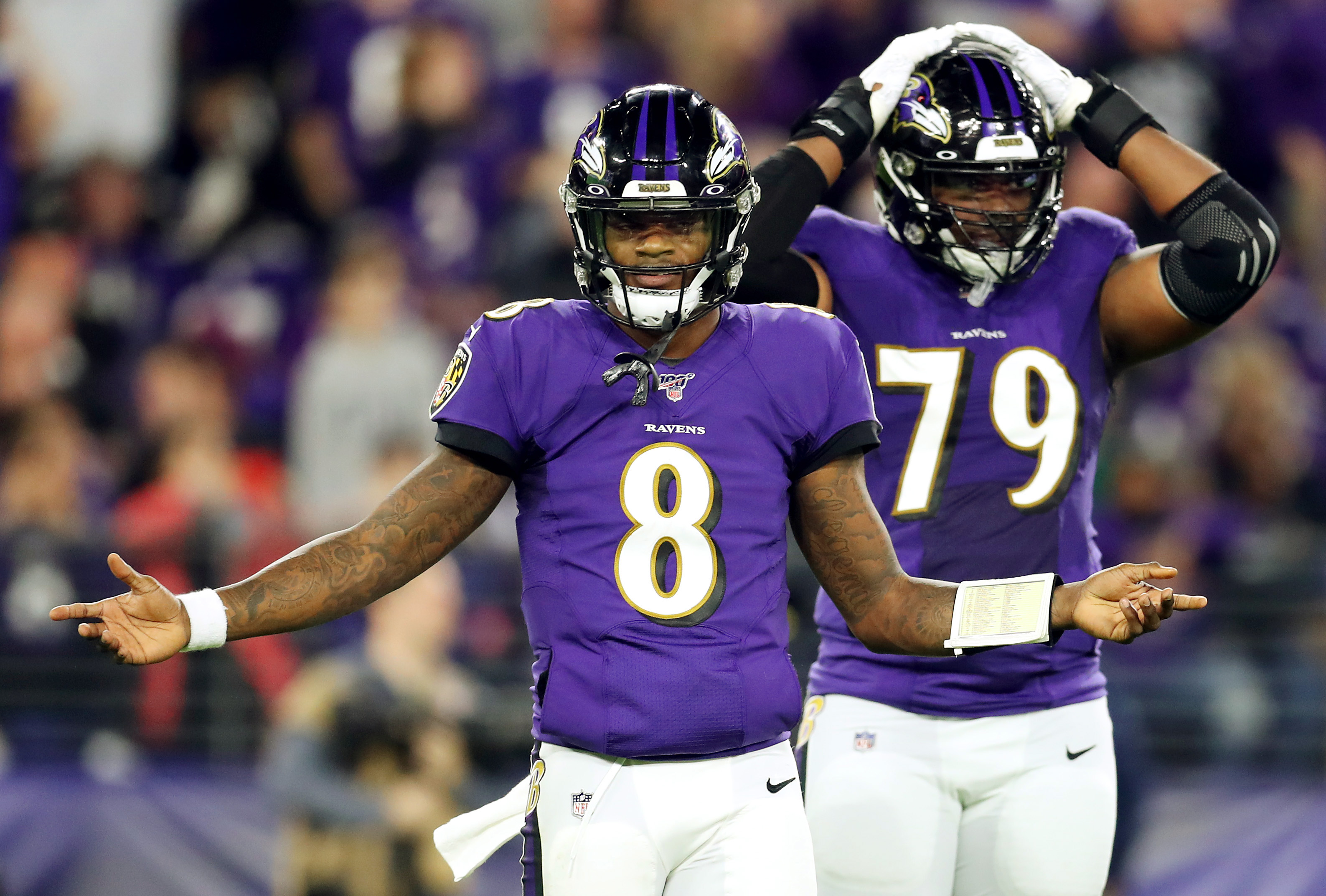 Ravens QB Lamar Jackson and Ronnie Stanley react during a playoff game