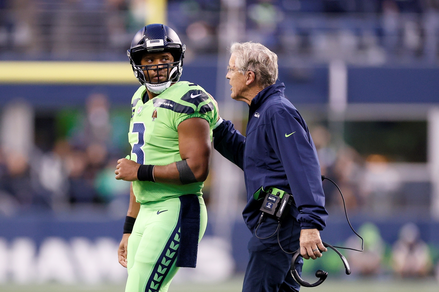 Seattle Seahawks head coach Pete Carroll speaks to quarterback Russell Wilson during a game against the Los Angeles Rams.