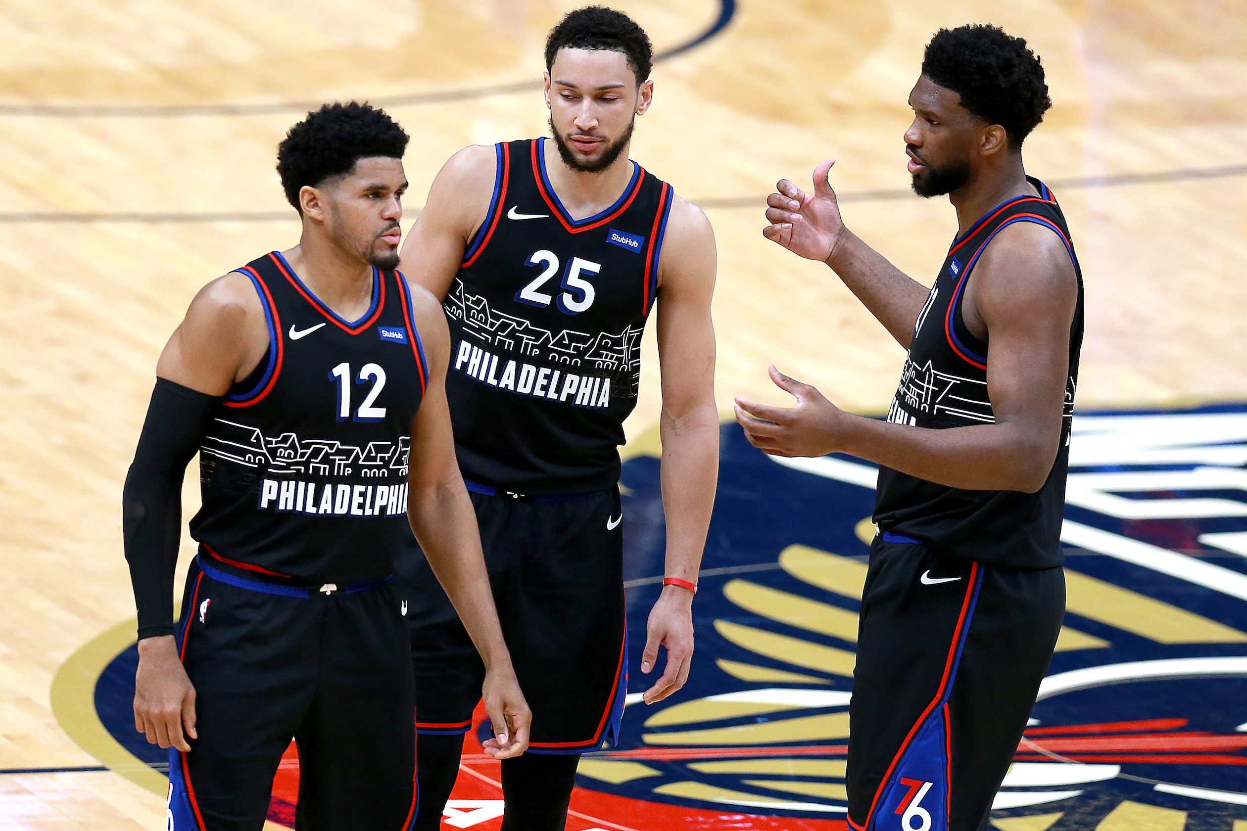 L-R: Tobias Harris, Ben Simmons, and Joel Embiid of the Philadelphia 76ers talk during a game in April