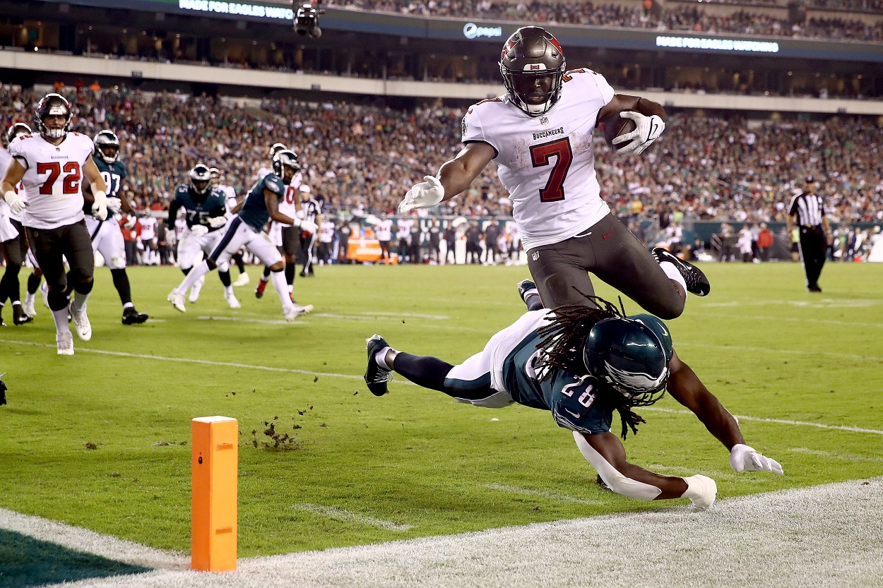 Leonard Fournette of the Tampa Bay Buccaneers jumps over a Philadelphia Eagles defender.