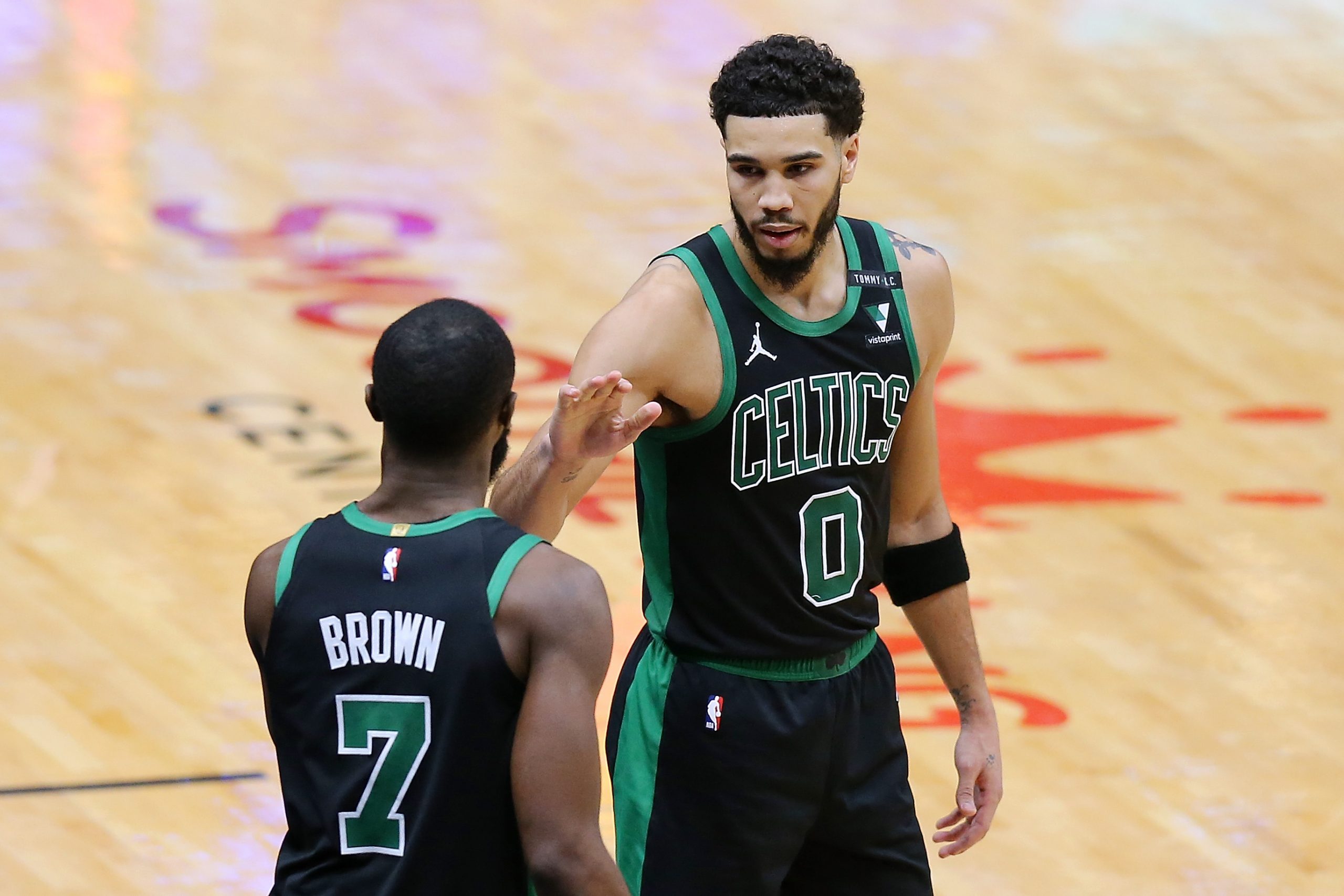 Jayson Tatum of the Boston Celtics talks to Jaylen Brown.