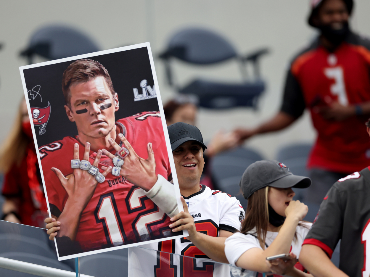 Tom Brady fans hold up a picture of the Tampa Bay Buccaneers quarterback.