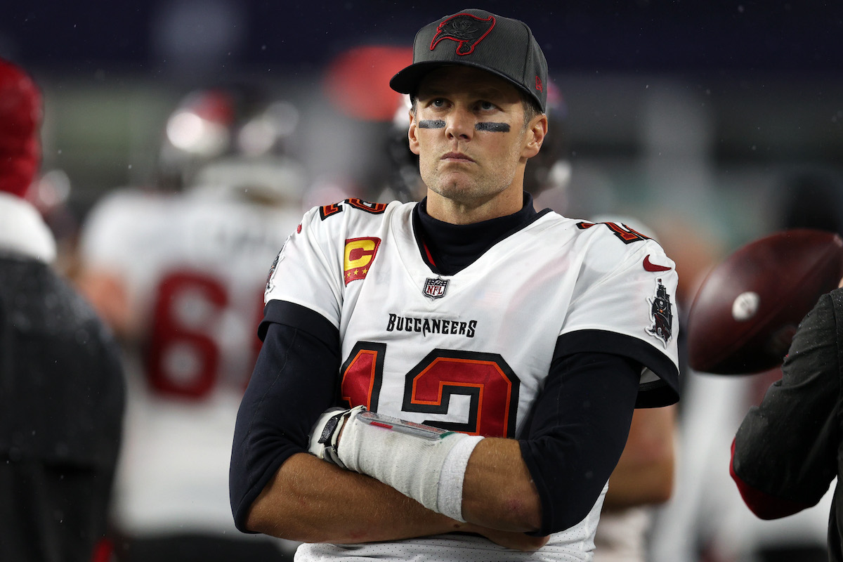 Tom Brady of the Tampa Bay Buccaneers looks on from the bench