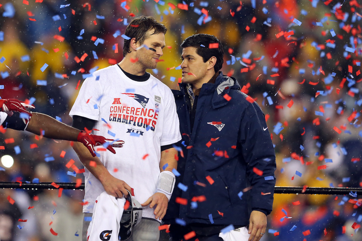 Tom Brady of the New England Patriots looks on with former Patriot Tedy Bruschi after defeating the Indianapolis Colts in the 2015 AFC Championship Game at Gillette Stadium on January 18, 2015 in Foxboro, Massachusetts. The Patriots defeated the Colts 45-7.
