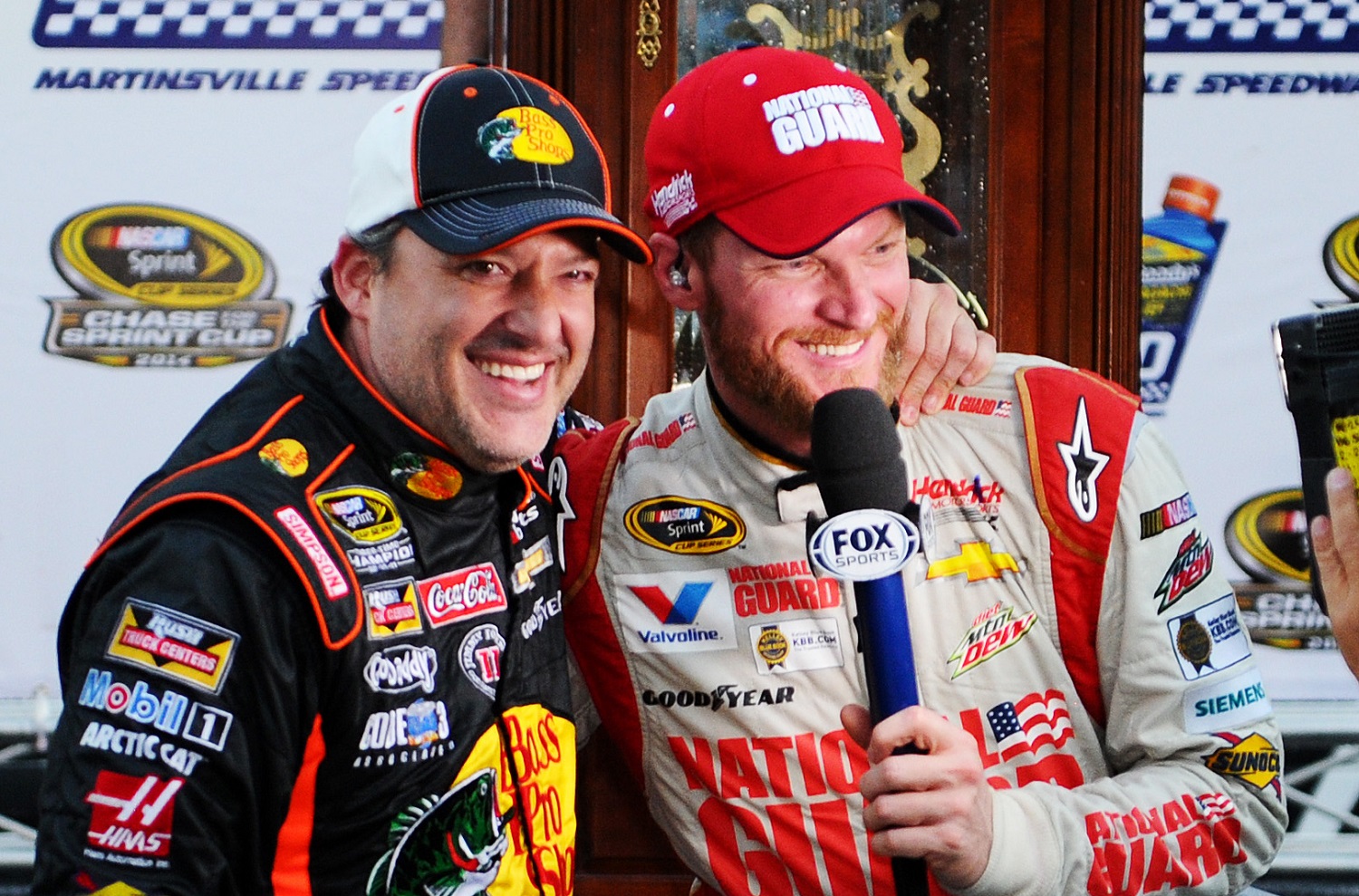 Dale Earnhardt Jr. is embraced by Tony Stewart after Earnhardt's victory in the NASCAR Sprint Cup Series Goody's Headache Relief Shot 500 at Martinsville Speedway on Oct. 26, 2014.