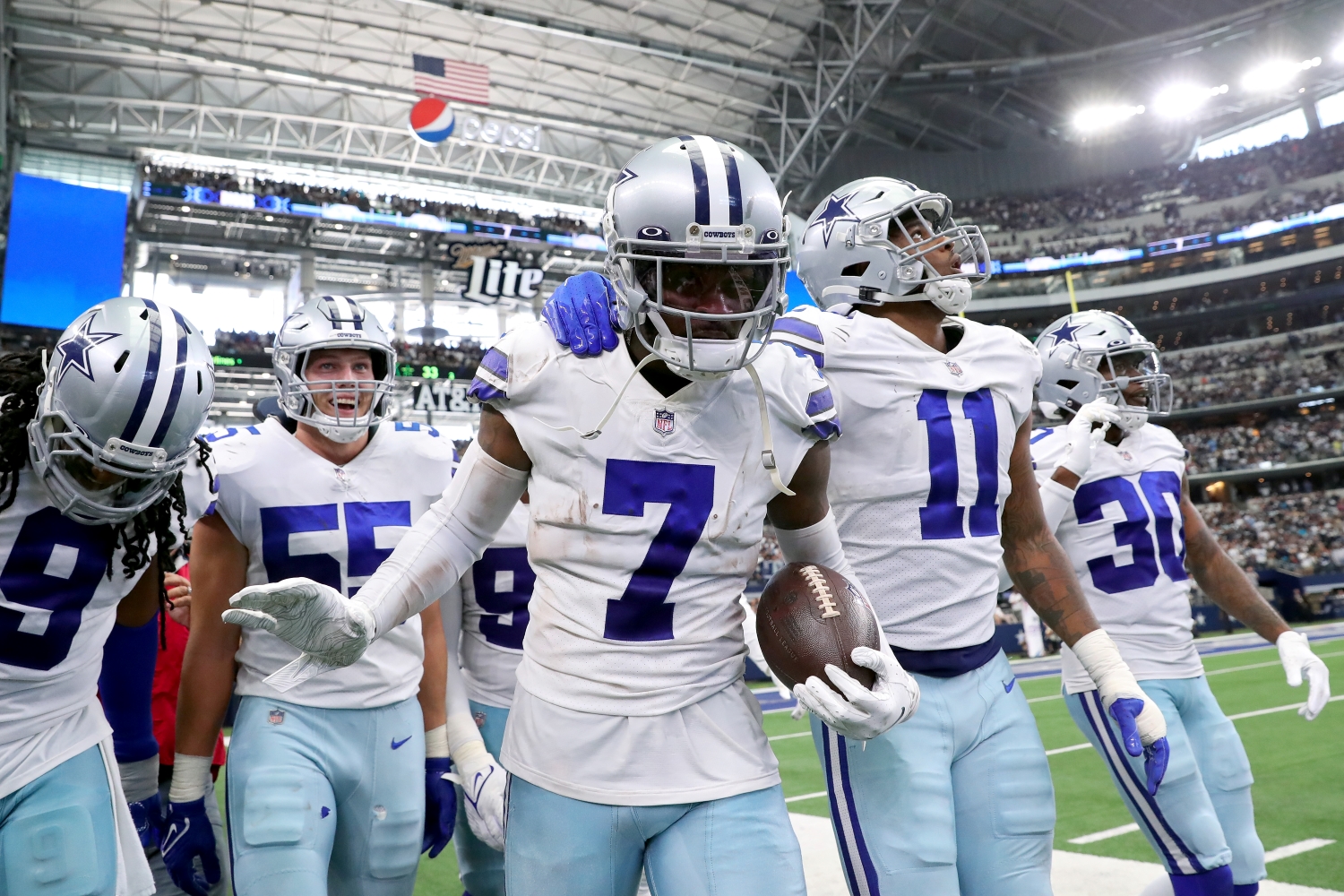 Cornerback Trevon Diggs celebrates recording an interception alongside his Dallas Cowboys teammates.