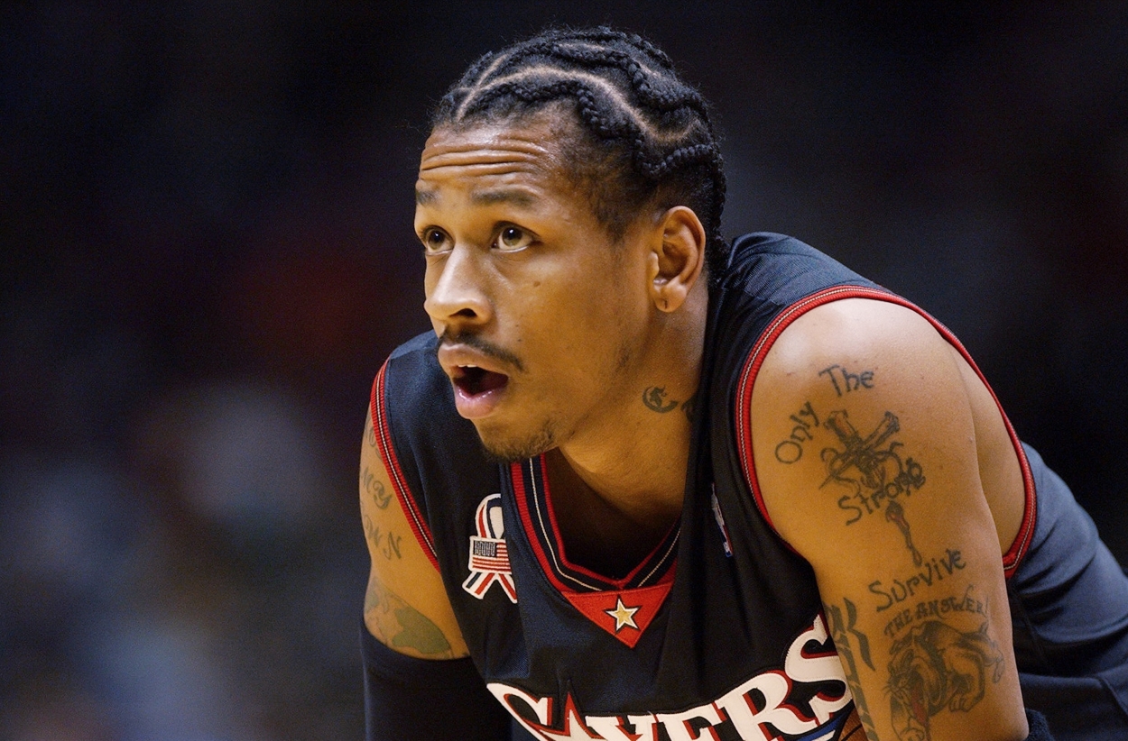 Allen Iverson leans over to catch his breath during a game.