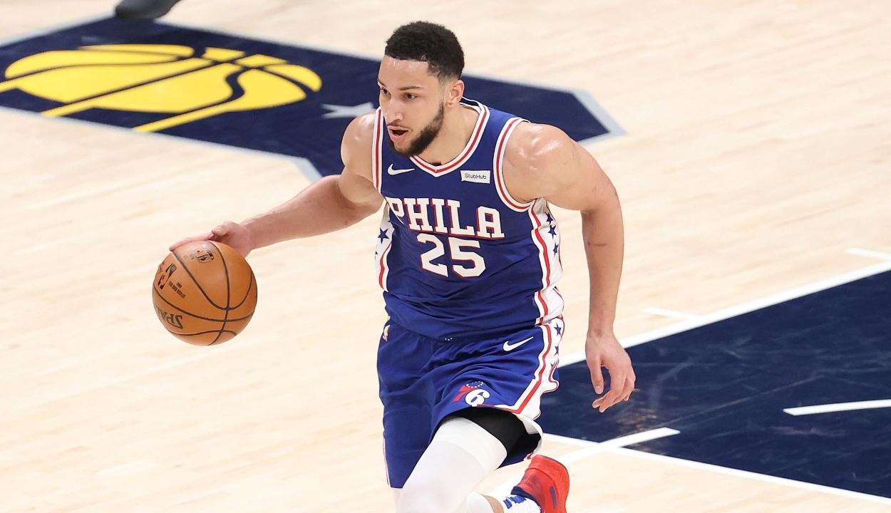 Ben Simmons of the Philadelphia 76ers dribbles past the Indiana Pacers half-court logo.
