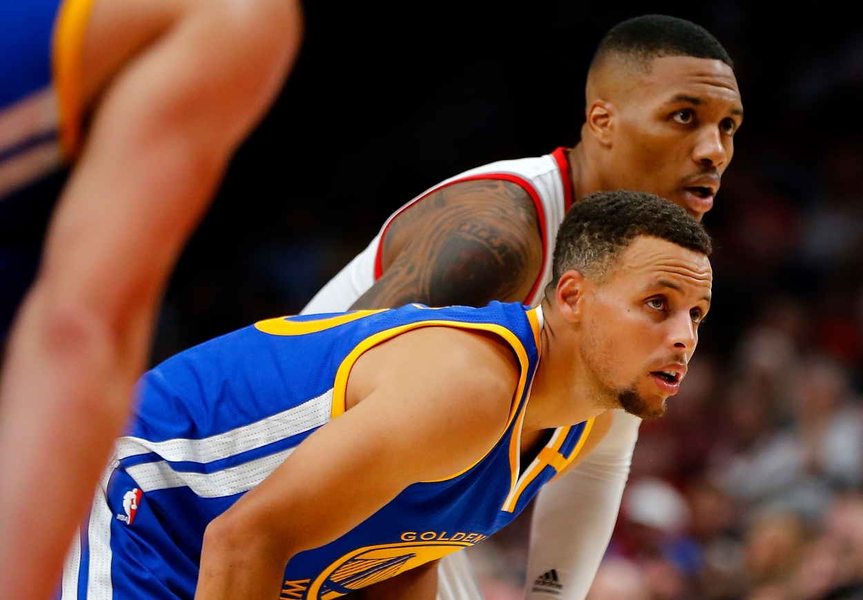 Damian Lillard of the Portland Trail Blazers and Stephen Curry of the Golden State Warriors stand together during a game.