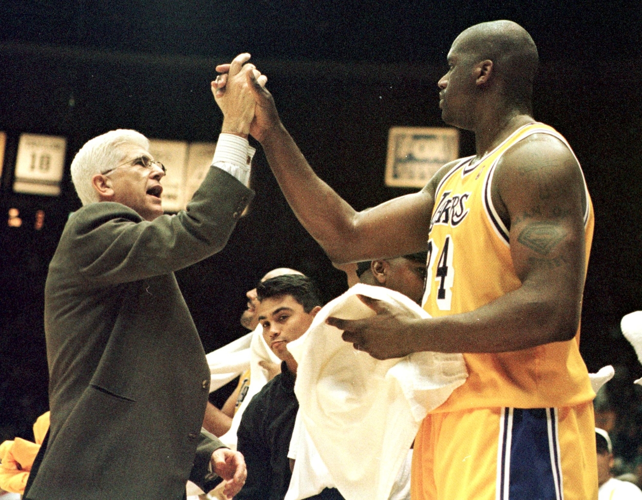 Del Harris high-fives Los Angeles Lakers center Shaquille O'Neal.