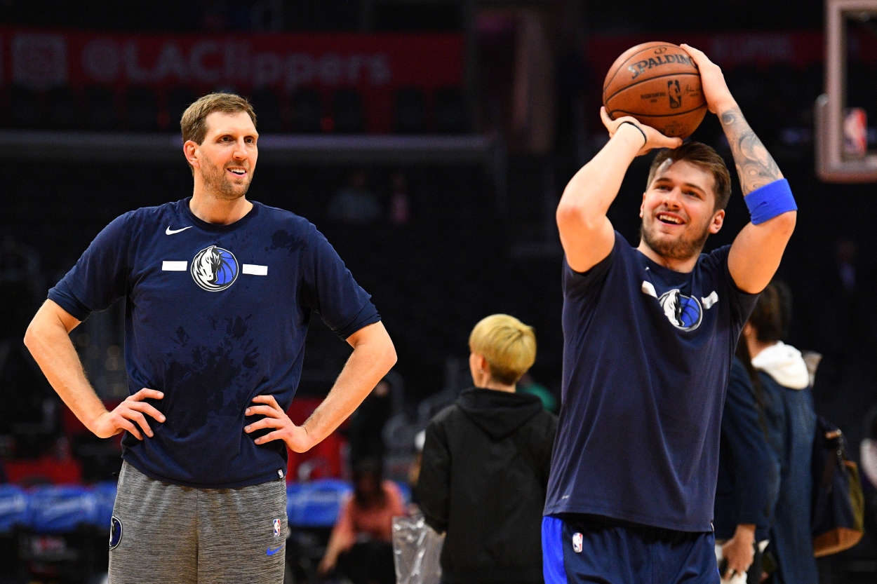 Dallas Mavericks forward Dirk Nowitzki watches Luka Doncic shoot during warmups.