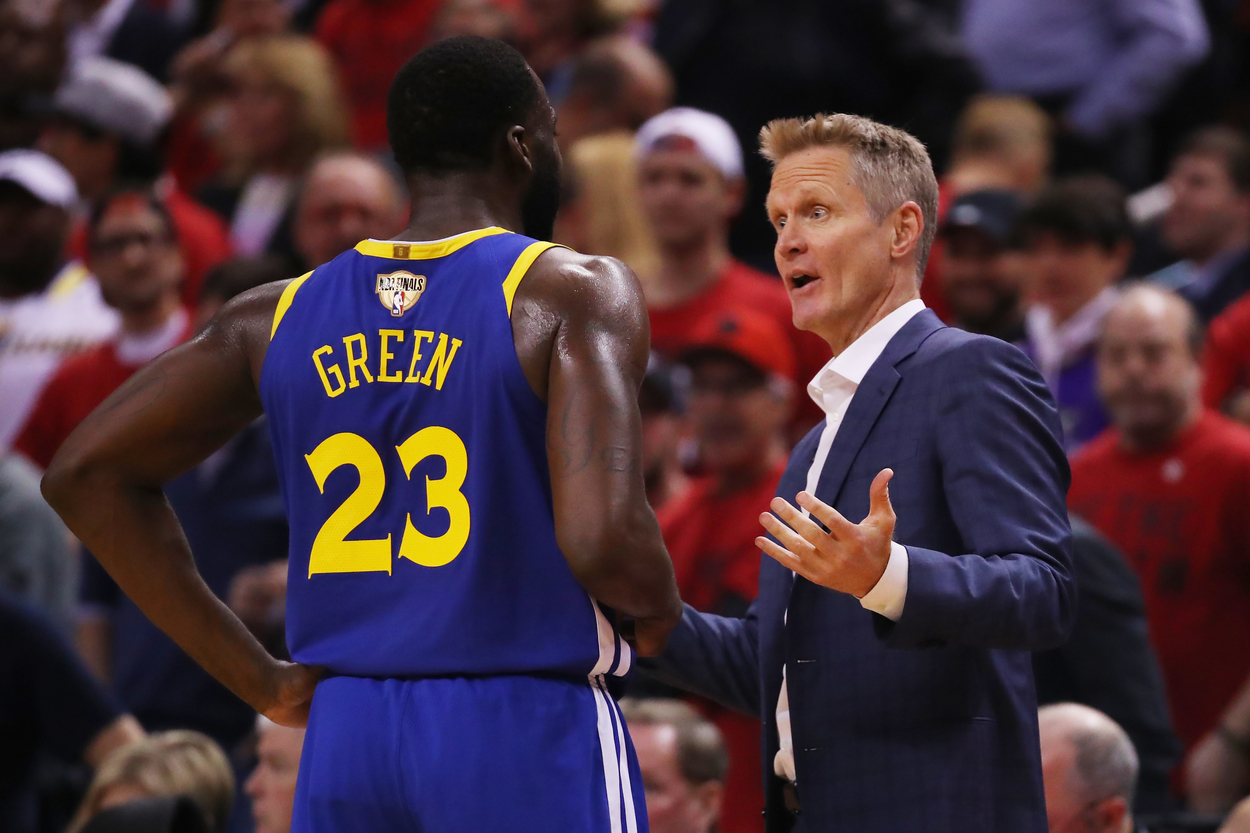 Draymond Green of the Golden State Warriors having a discussion with Steve Kerr.