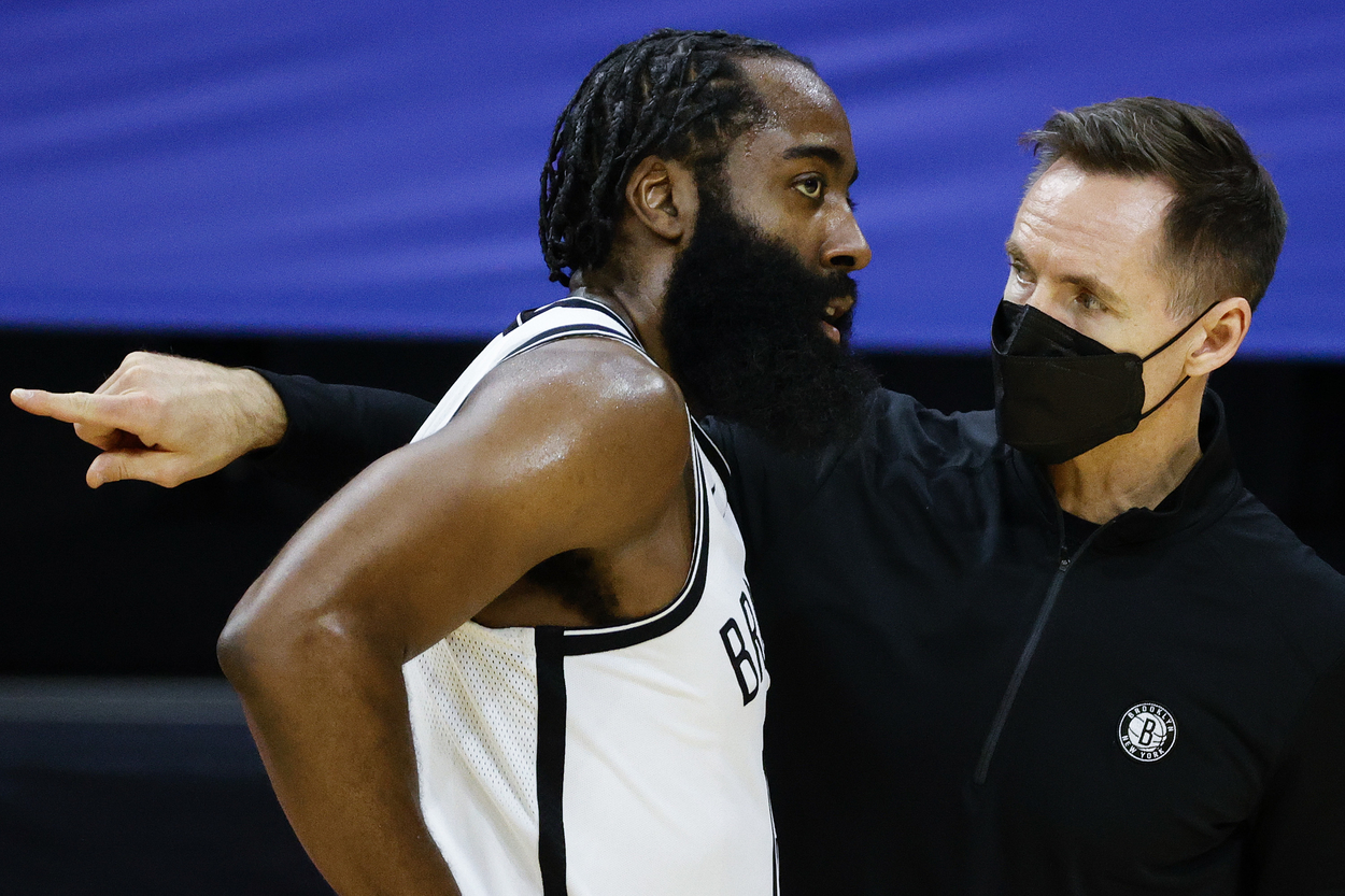 Brooklyn Nets head coach Steve Nash giving instructions to James Harden during a game.