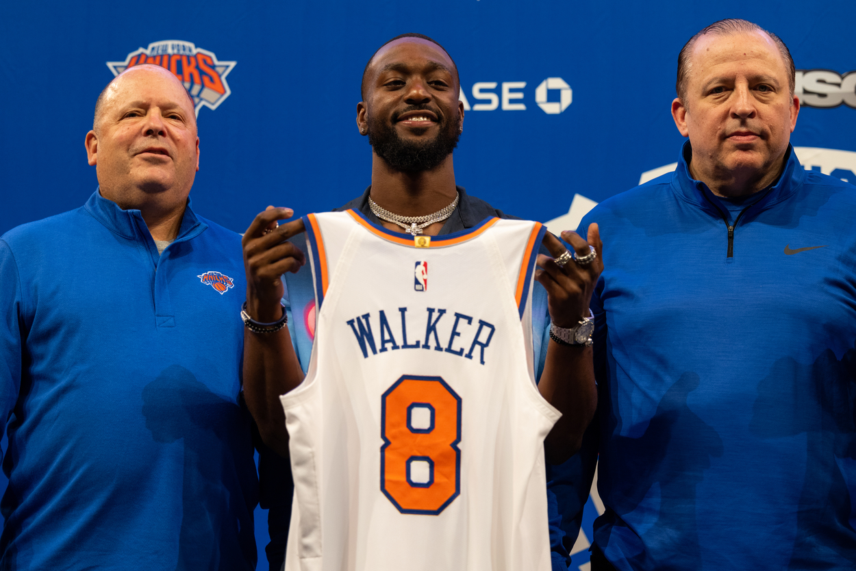 Kemba Walker holds up his New York Knicks #8 jersey.