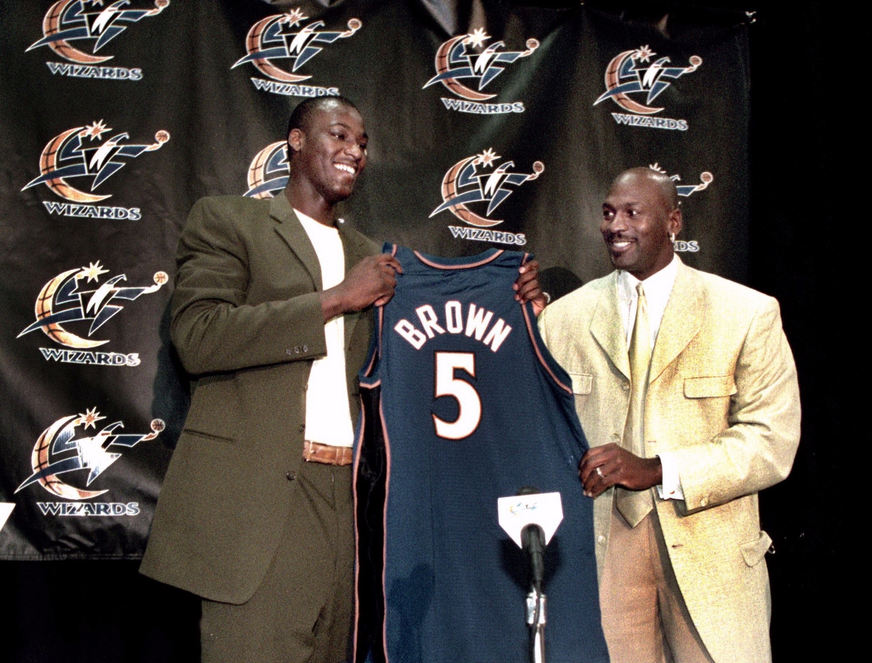 Michael Jordan hands Kwame Brown his first Washington Wizards jersey at a press conference.