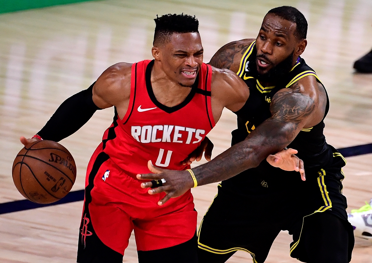 LeBron James of the Los Angeles Lakers guards Russell Westbrook.
