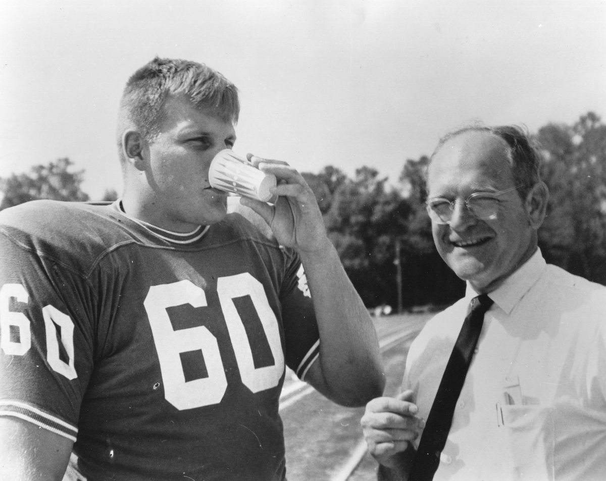 James Benson, #60 offensive guard of the University of Florida Gators football team drinks a cup of Gatorade during a practice at Florida Field in Gainesville, Florida in 1965.
