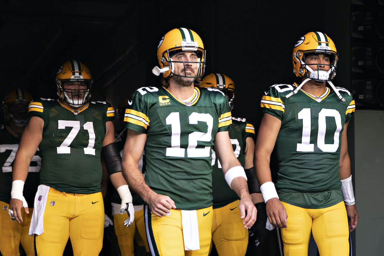 Aaron Rodgers and Jordan Love of the Green Bay Packers walk onto the field before a game against the Detroit Lions at Lambeau Field on September 20, 2021 in Green Bay, Wisconsin. The Packers defeated the Lions 35-17.