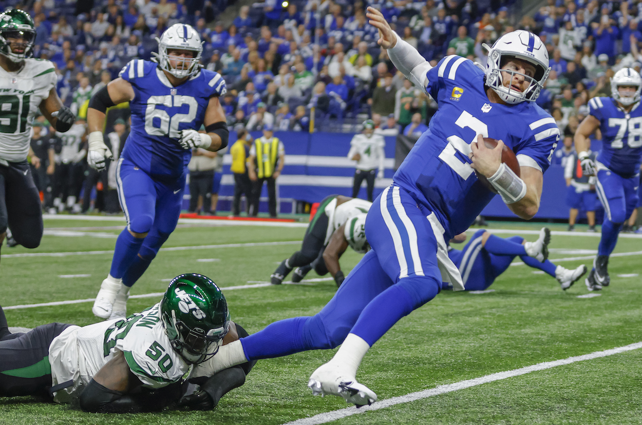 Colts QB Carson Wentz trying to elude a Jets defender