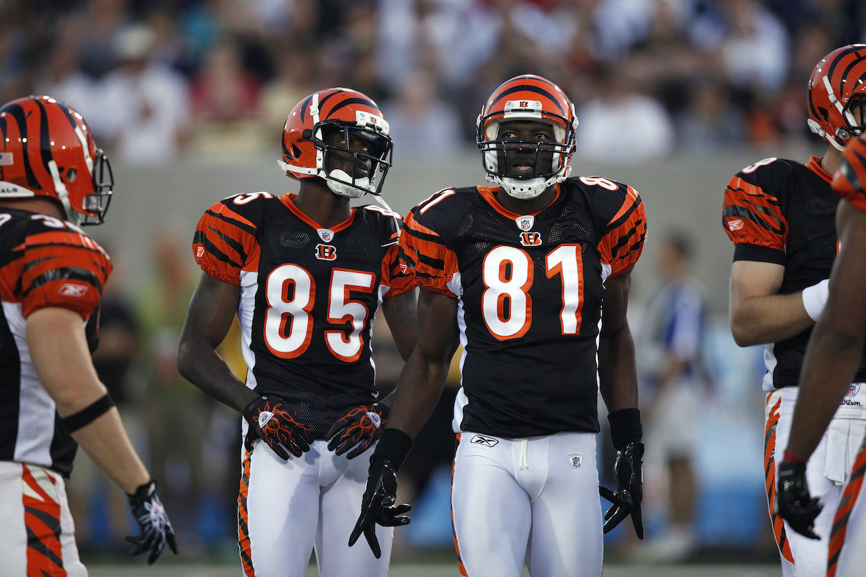 Chad Ochocinco and Terrell Owens who played with Carson Palmer on the Cincinnati Bengals look on against the Dallas Cowboys during the 2010 Pro Football Hall of Fame Game at the Pro Football Hall of Fame Field at Fawcett Stadium on August 8, 2010 in Canton, Ohio.