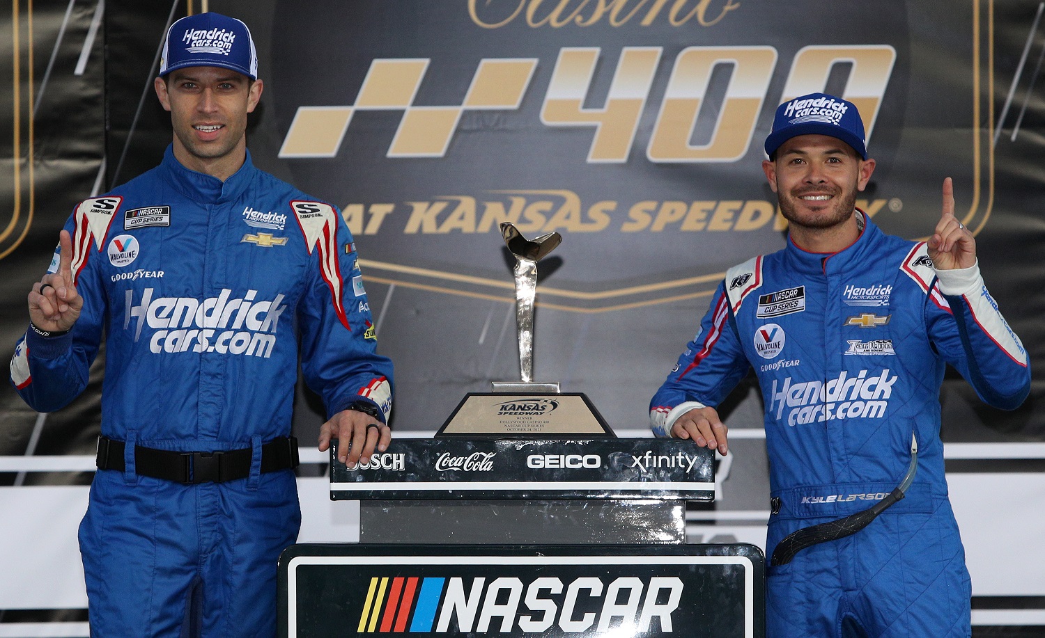 Crew chief Cliff Daniels and driver Kyle Larson of Hendrick Motorsports celebrate in victory lane after winning the NASCAR Cup Series Hollywood Casino 400 at Kansas Speedway on Oct. 24, 2021.