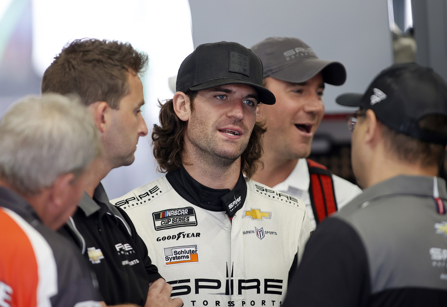 Corey LaJoie, driver of the No. 7 Chevy, talks with crew in the garage area during the NASCAR Cup Series test at the Charlotte Motor Speedway on Oct. 11, 2021.