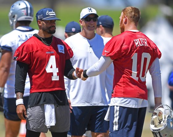 Dallas Cowboys quarterbacks Dak Prescott and Cooper Rush talk during training camp.