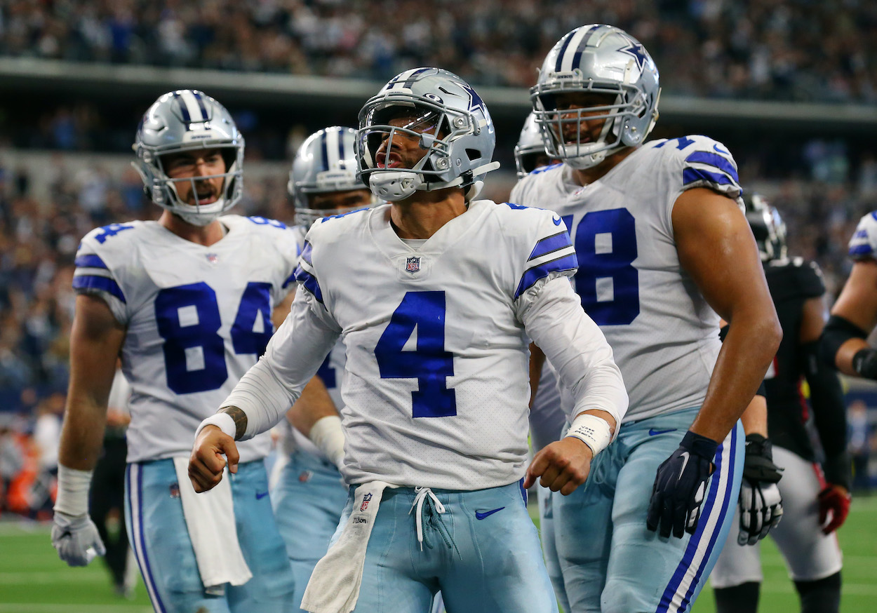 Dak Prescott of the Dallas Cowboys celebrates his rushing touchdown against the Atlanta Falcons during the third quarter at AT&T Stadium on November 14, 2021 in Arlington, Texas.