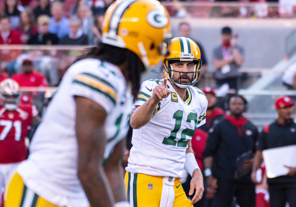 Green Bay Packers quarterback Aaron Rodgers makes a gesture to wide receiver Davante Adams.
