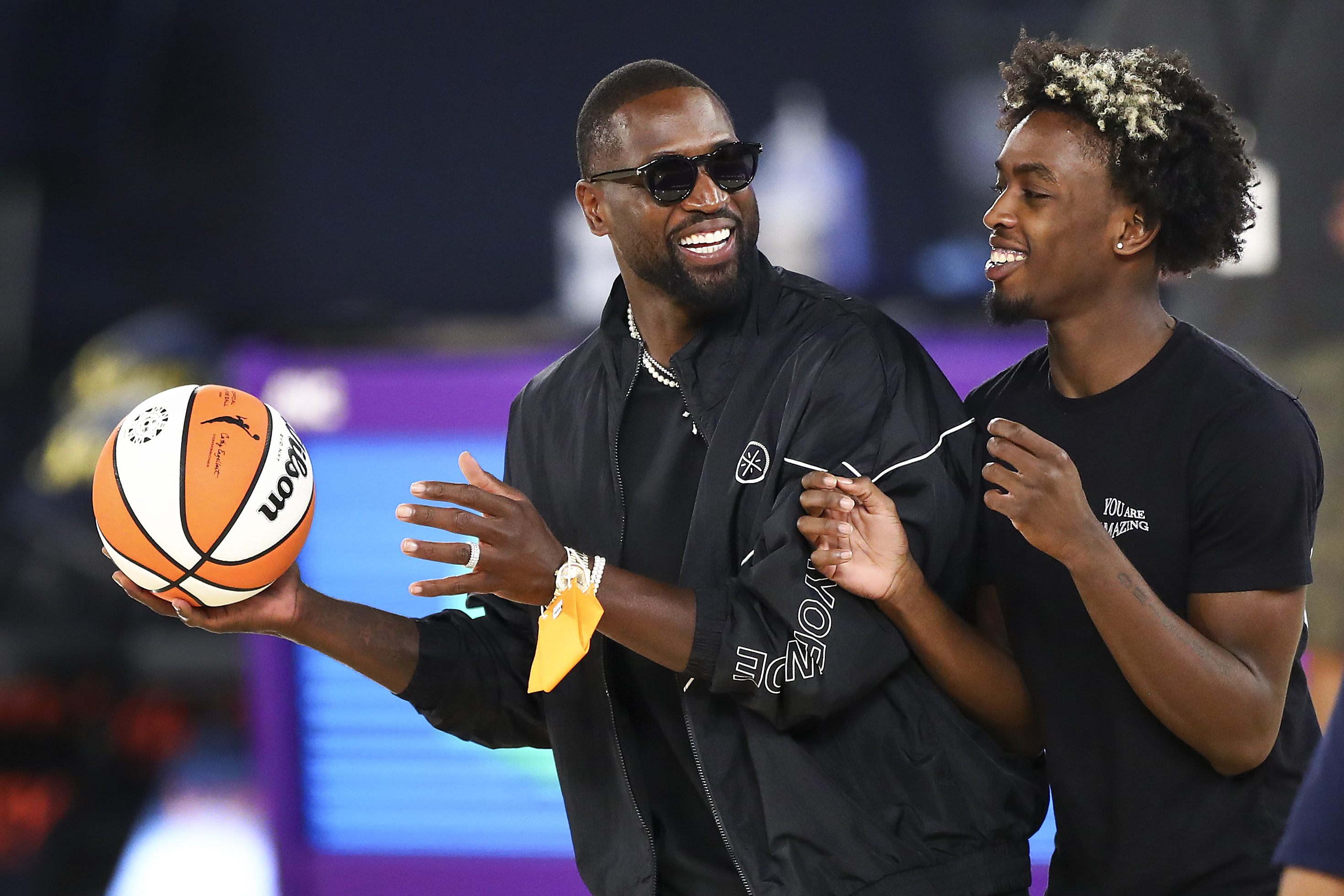 Former Miami Heat star and Utah Jazz part-owner Dwyane Wade at a WNBA game with his son, Zaire