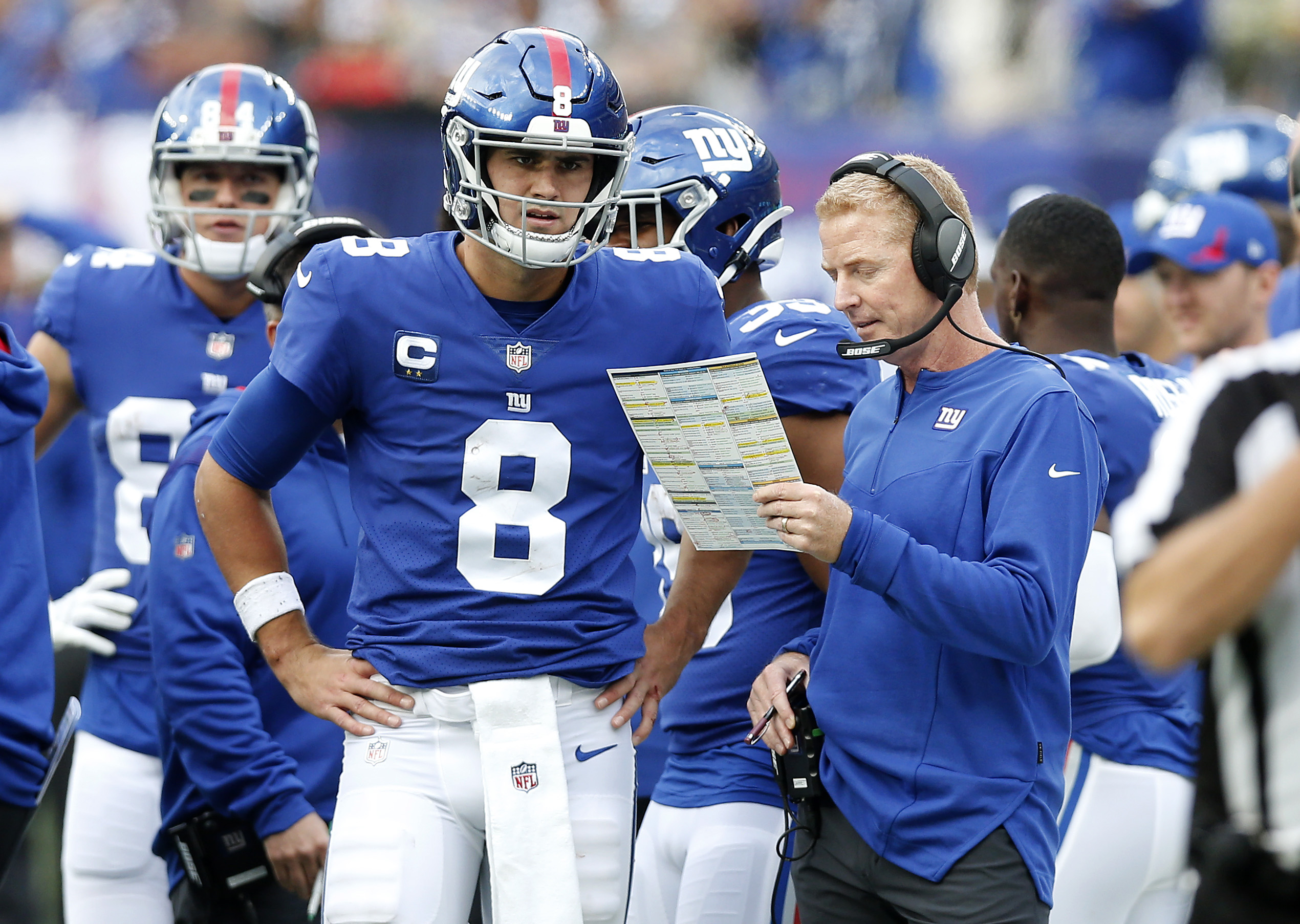 Former Giants OC Jason Garrett next to Daniel Jones.