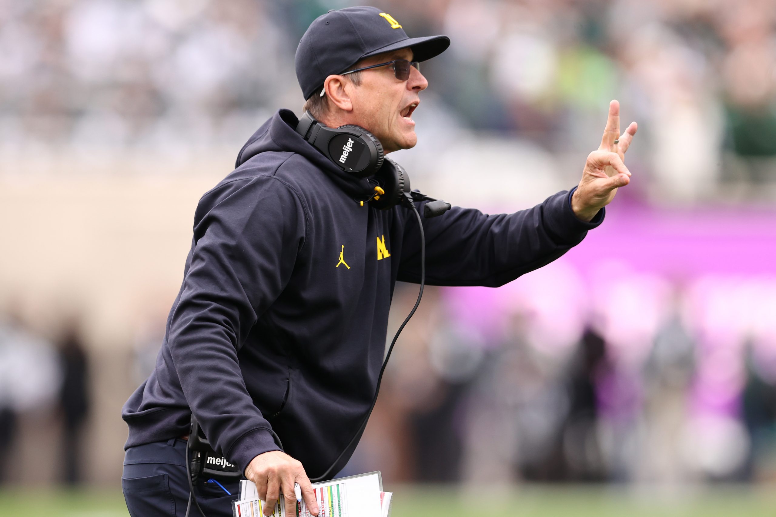 Head coach Jim Harbaugh reacts while playing the Michigan State Spartans.