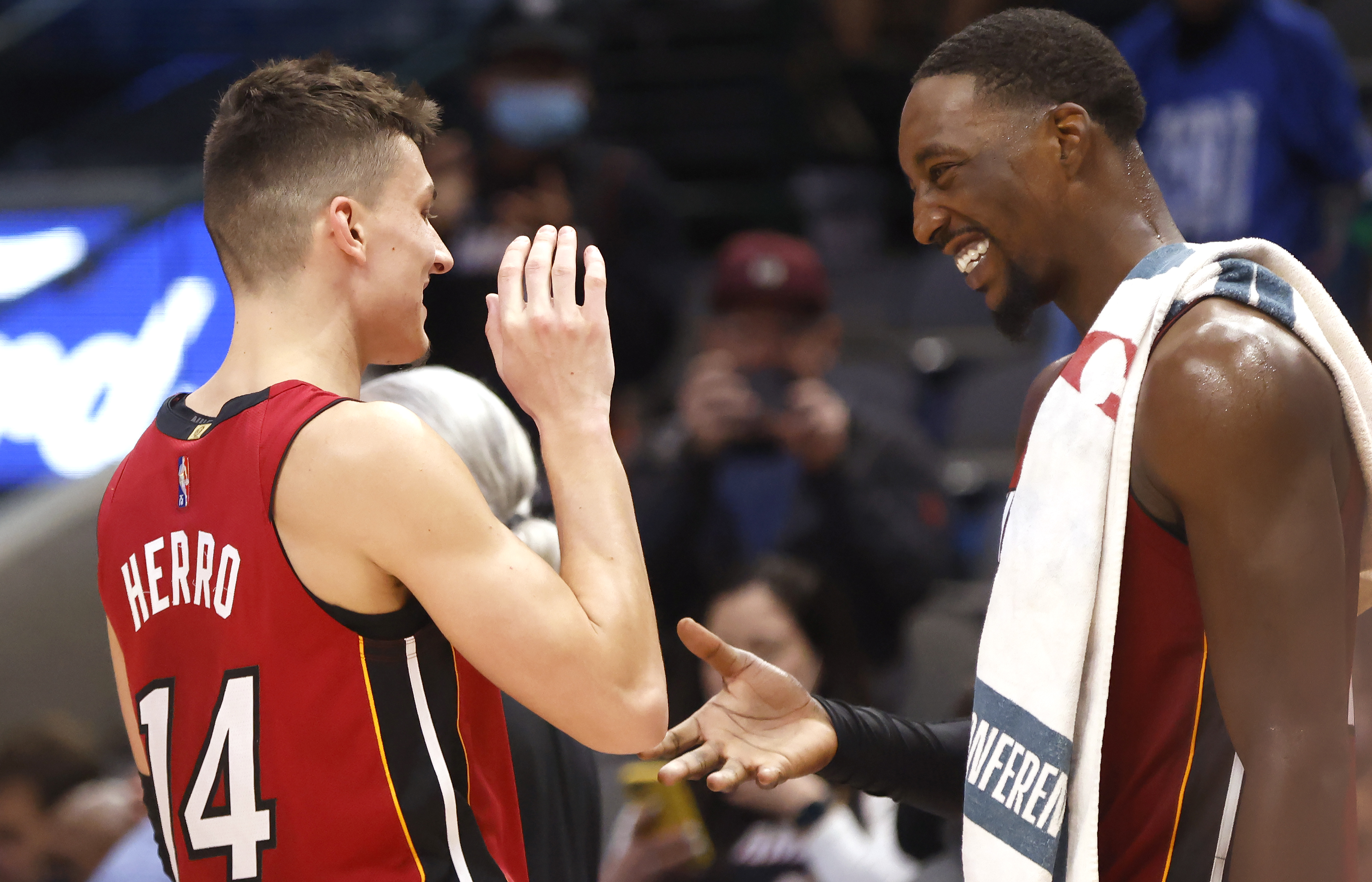 Miami Heat guard Tyler Herro high-fives Heat center Bam Adebayo during a game against the Dallas Mavericks